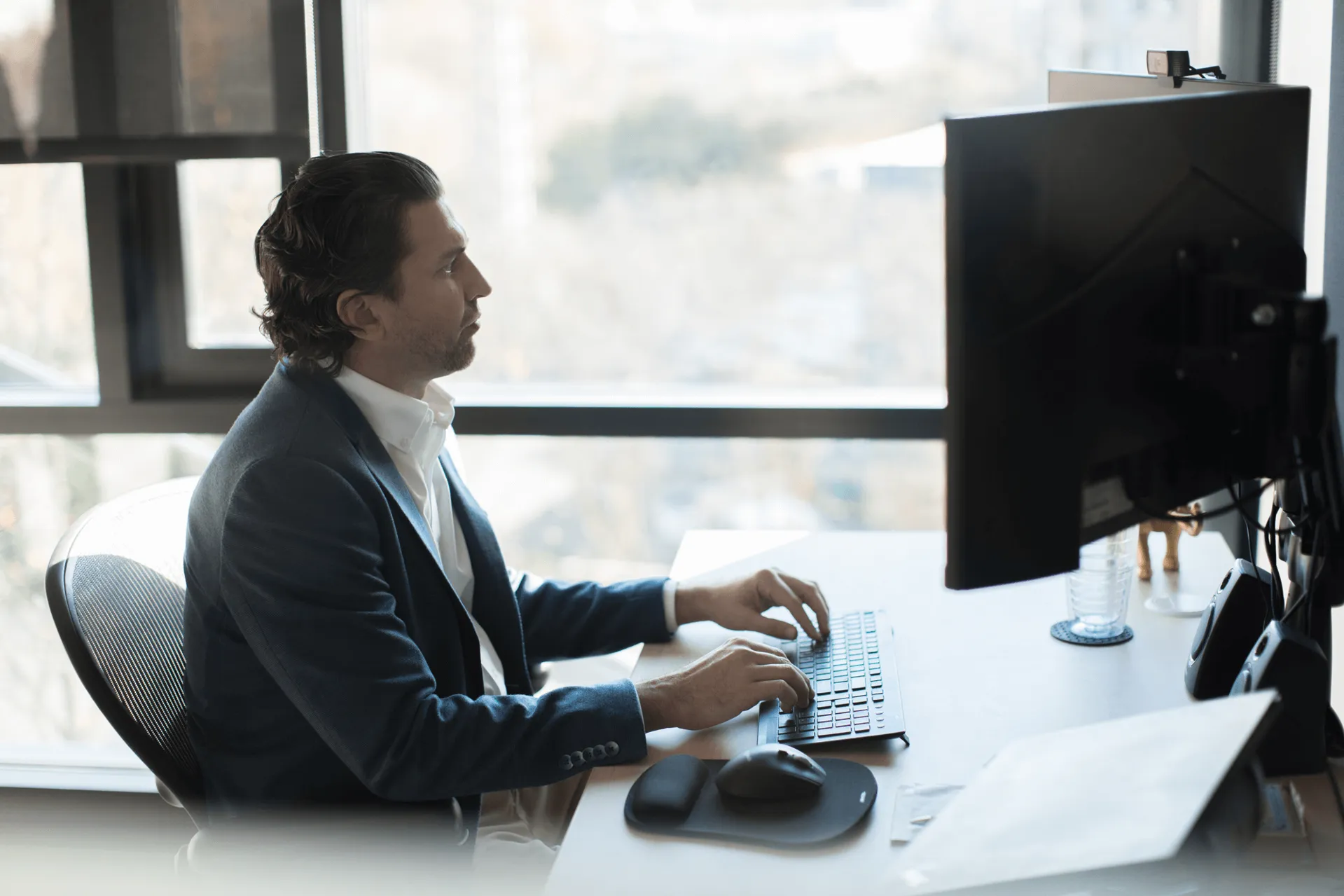 man typing on computer