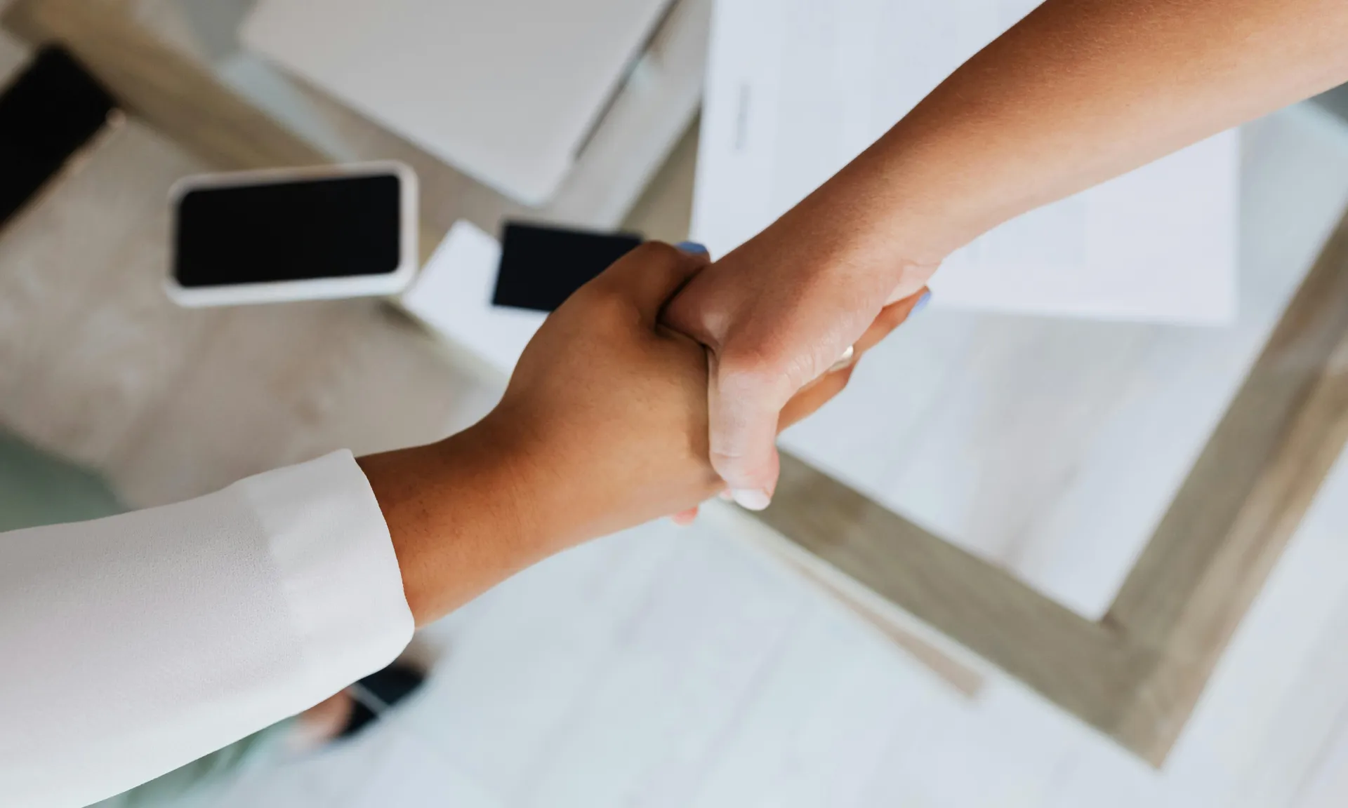 Two people shaking hands in a business meeting